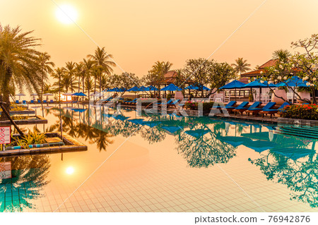 palm tree with umbrella chair pool in luxury hotel resort at sunrise times palm tree with umbrella chair pool in luxury hotel resort at sunrise times 76942876