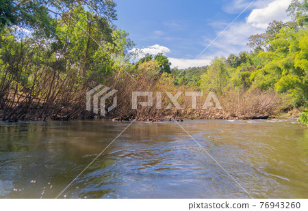Sailing on lake or river water rafting, paddling on boat canal in park. Sightseeing in forest trees at Mae Sot ,Tak, Thailand. Nature landscape. Tourist adventure activity. Travel in holiday vacation. Sailing on lake or river water rafting, paddling on boat canal in park. Sightseeing in forest trees at Mae Sot ,Tak, Thailand. Nature landscape. Tourist adventure activity. Travel in holiday vacation. 76943260