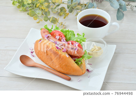 Breakfast hot dog image. Put sausage grilled and tomato lettuce in bread. 76944498