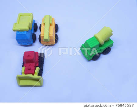 Miniature model of construction heavy machine made from colorful synthetic rubber isolated on white background.  76945557