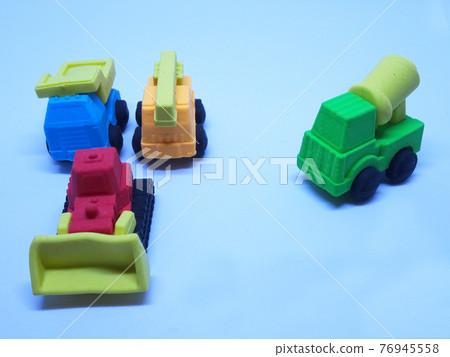 Miniature model of construction heavy machine made from colorful synthetic rubber isolated on white background.  76945558