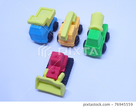 Miniature model of construction heavy machine made from colorful synthetic rubber isolated on white background.  76945559