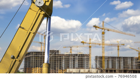 Part of a construction machine (excavator or crane) on the background construction site, industrial image. Moscow, Russia Part of a construction machine (excavator or crane) on the background construction site, industrial image. Moscow, Russia 76946508