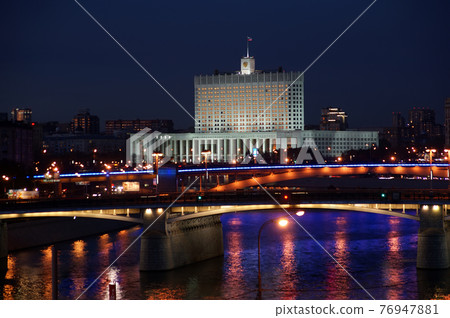 Moscow, Russia. Night. View from the embankment of the Moskva River.  Borodinsky bridge, Smolensky Metro Bridge and White House of Russia behind it. 76947881
