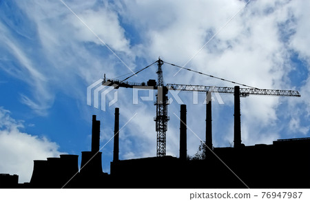 Pipes of coal  burning power station and construction crane. Moscow, Russia 76947987