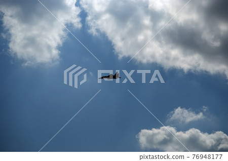 Flight of modern combat fighters on the sky background Flight of modern combat fighters on the sky background 76948177