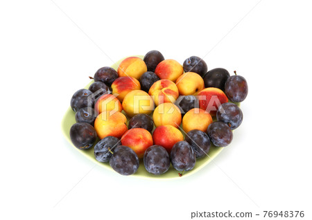 Still life with natural ripe plums and peaches on a white background 76948376