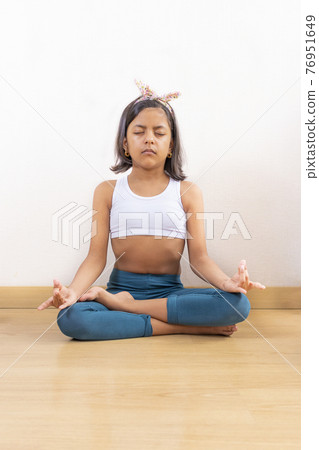 Teen girl doing yoga at home 76951649