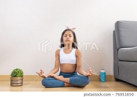 Teen girl doing yoga at home 76951650