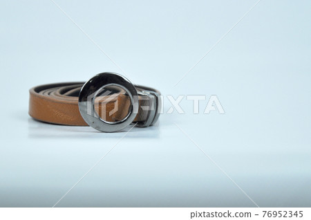 Brown lady waist belt isolated on white background.The waist belt was made from PU leather. Brown lady waist belt isolated on white background.The waist belt was made from PU leather. 76952345