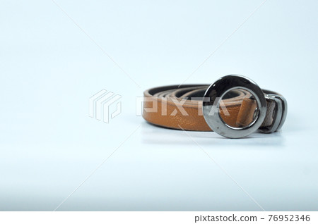Brown lady waist belt isolated on white background.The waist belt was made from PU leather. Brown lady waist belt isolated on white background.The waist belt was made from PU leather. 76952346