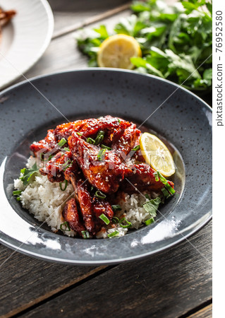 Asian style honey glazed chicken, coriander leaves, rice and lemon Asian style honey glazed chicken, coriander leaves, rice and lemon 76952580