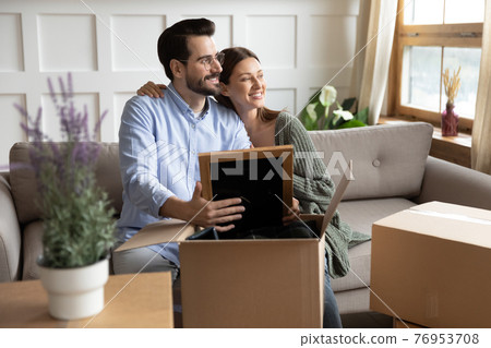 Happy Caucasian couple unpacking on moving day 76953708