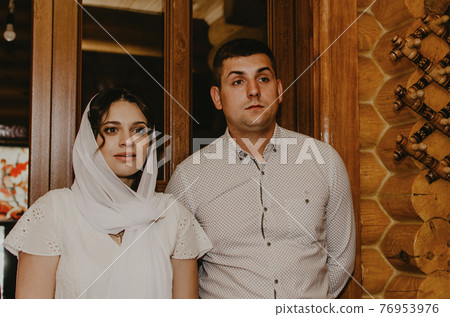 rite of sacrament of epiphany child baby in church. God-parents 76953976