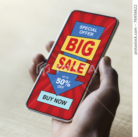 Black guy hand with big sale advertisement on smartphone Black guy hand with big sale advertisement on smartphone 76956622