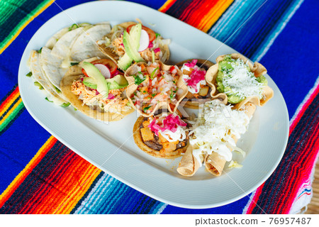Mexican Vegetarian Tacos on a white plate in a Restaurant Mexican Vegetarian Tacos on a white plate in a Restaurant 76957487