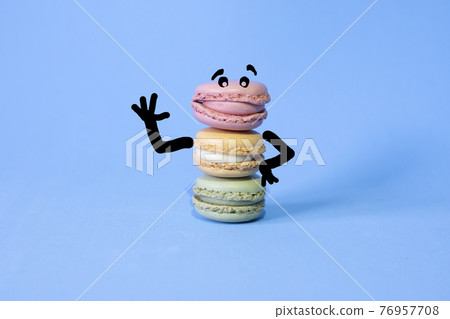 cartoon drawn on coloured macarons on a blue background cartoon drawn on coloured macarons on a blue background 76957708