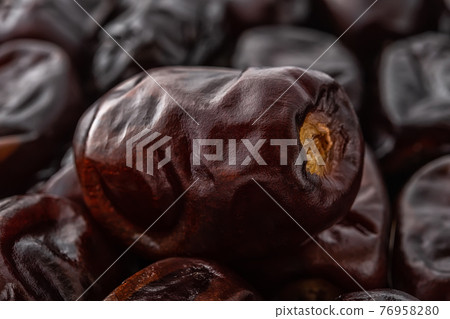 Dried dates close-up. Macro shot of delicious dried date fruits. Dried dates close-up. Macro shot of delicious dried date fruits. 76958280