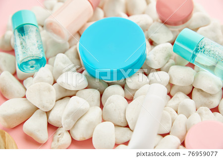 Skin care products on pebbles, pink background 76959077