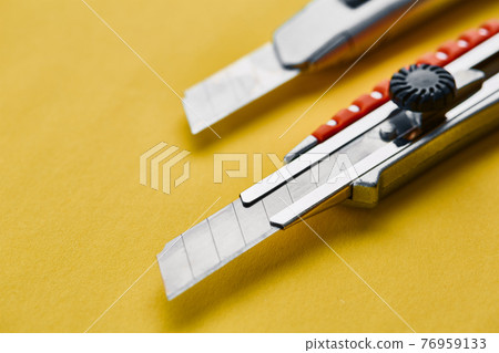 Razor, construction knife, yellow background Razor, construction knife, yellow background 76959133