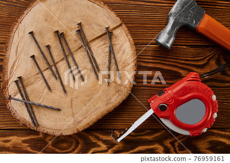 Screw nails, hammer and measuring tape, top view Screw nails, hammer and measuring tape, top view 76959161