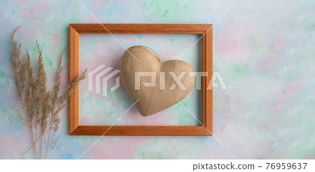 A frame with a heart in the papier mache technique and Pampas dry grass on a delicate background . Valentine's Day concept, greeting card, banner for the holiday. A frame with a heart in the papier mache technique and Pampas dry grass on a delicate background . Valentine's Day concept, greeting card, banner for the holiday. 76959637