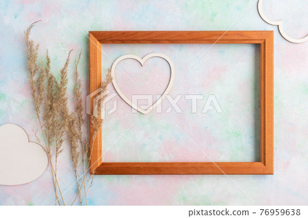 A frame with a heart and Pampas dry grass on a delicate background with space for text. Valentine's Day concept, greeting card, banner for the holiday. A frame with a heart and Pampas dry grass on a delicate background with space for text. Valentine's Day concept, greeting card, banner for the holiday. 76959638