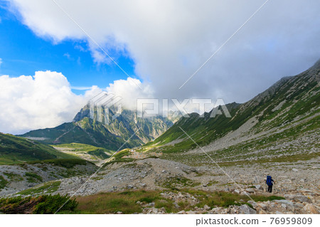 People who follow the majestic mountains and mountain trails 76959809
