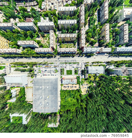 Aerial city view with crossroads and roads, houses, buildings, parks and parking lots. Sunny summer panoramic image Aerial city view with crossroads and roads, houses, buildings, parks and parking lots. Sunny summer panoramic image 76959845