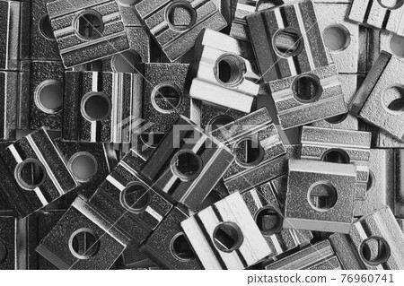 slide screw nuts heap, closeup view 76960741