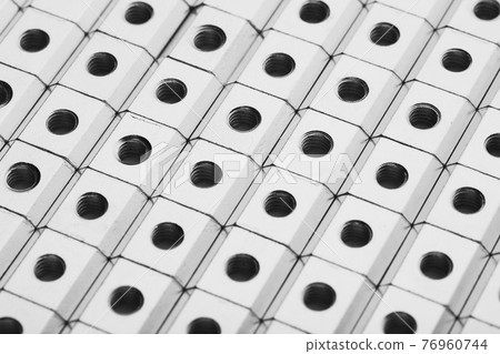 slide screw nuts in a row, abstract industrial background slide screw nuts in a row, abstract industrial background 76960744