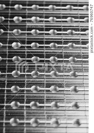 slide screw nuts in a row, abstract industrial background slide screw nuts in a row, abstract industrial background 76960747