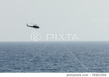 helicopter flying over blue sea helicopter flying over blue sea 76961008