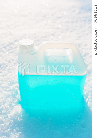 bottle with non-freezing windshield washer fluid, snow background bottle with non-freezing windshield washer fluid, snow background 76961518