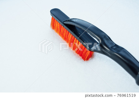 orange snow brush for car, snowflakes background 76961519