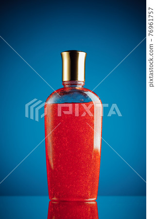 red shower gel on blue background 76961757