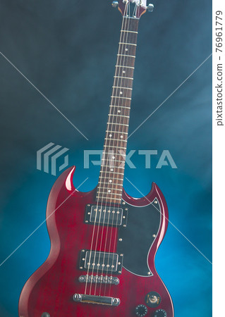 electric guitar in smoke, blue background electric guitar in smoke, blue background 76961779