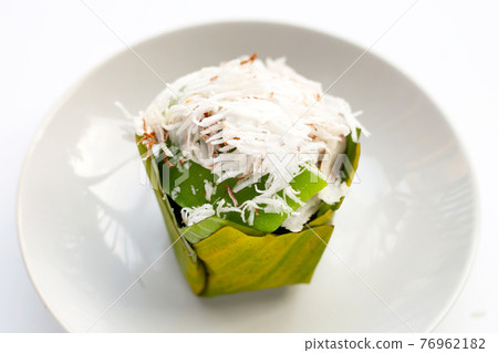 Pandanus pudding in banana leaves with coconut topping Pandanus pudding in banana leaves with coconut topping 76962182