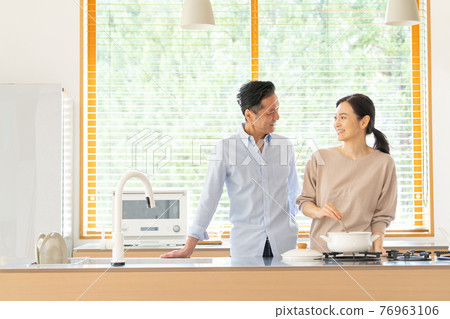 Middle couple cooking in the kitchen 76963106