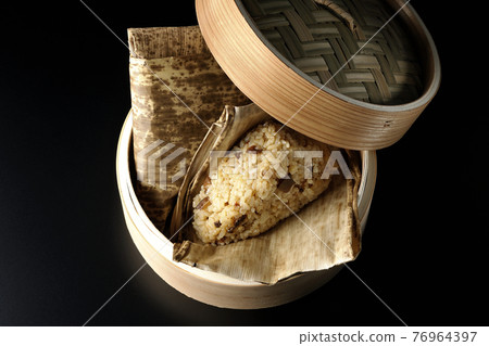 A picture of steamed Chinese rice dumplings on a black background (overhead view) A picture of steamed Chinese rice dumplings on a black background (overhead view) 76964397