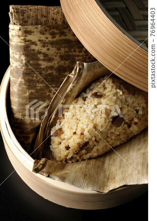 A picture of steamed Chinese rice dumplings on a black background (overhead view) A picture of steamed Chinese rice dumplings on a black background (overhead view) 76964403