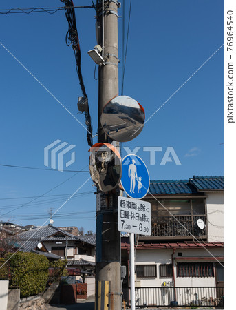 Utility poles and curved mirrors in the blue sky 76964540