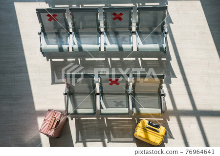 Airport termimal chairs with social distancing sign 76964641