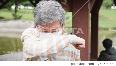 Asian man cough in elbow Asian man cough in elbow 76968078