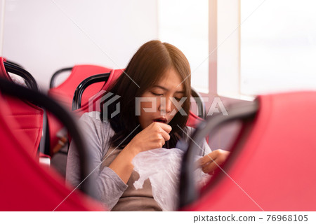 Woman suffering from sea sickness and feeling throw up in plasatic bagwhile on boat Woman suffering from sea sickness and feeling throw up in plasatic bagwhile on boat 76968105