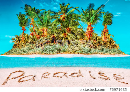 Whole tropical island within atoll in tropical Ocean and inscription "Paradise" in the sand on a tropical island. 76971685