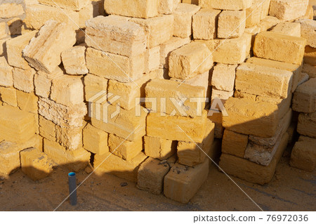 large pile of shell bricks, building a house from an environmentally friendly material 76972036