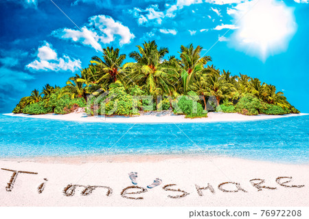 Whole tropical island within atoll in tropical Ocean and inscription "TimeShare" in the sand on a tropical island,  Maldives. 76972208