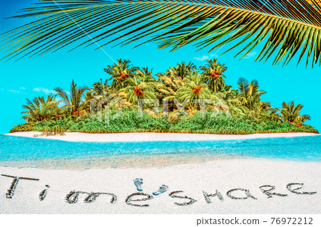 Whole tropical island within atoll in tropical Ocean and inscription "TimeShare" in the sand on a tropical island,  Maldives. 76972212