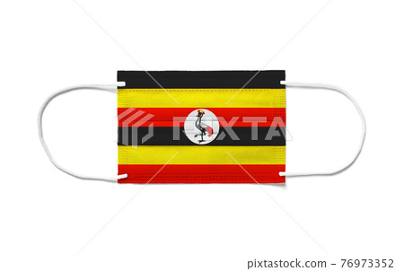 Flag of Uganda on a disposable surgical mask. White background Flag of Uganda on a disposable surgical mask. White background 76973352